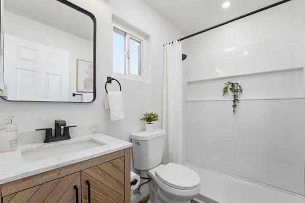 a kitchen with white cabinets and sink