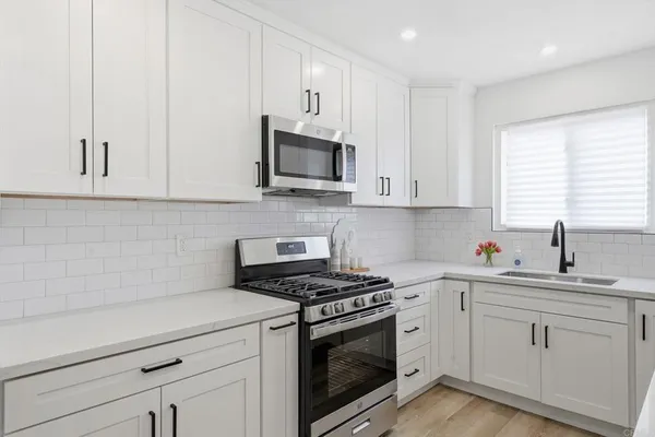 a kitchen with stainless steel appliances a stove a microwave and cabinets