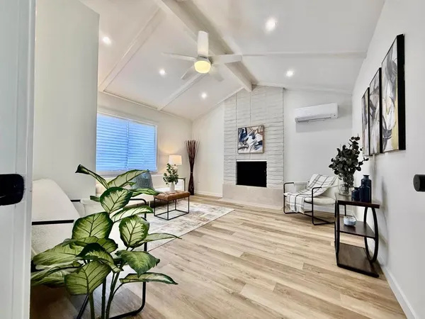 a kitchen with stainless steel appliances granite countertop a refrigerator a stove a sink dishwasher and white cabinets with wooden floor