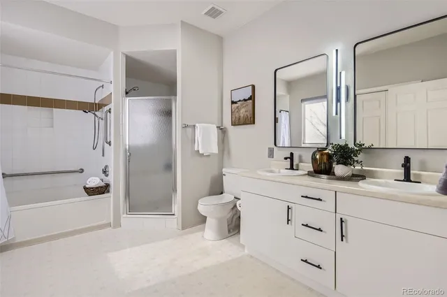 a bathroom with a glass shower door and a window