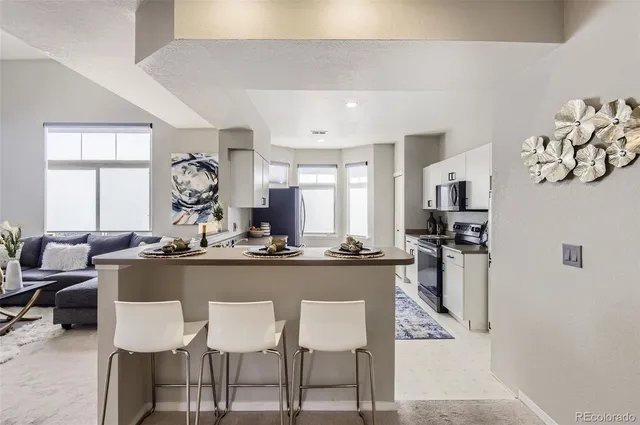 a kitchen with a sink stove and refrigerator