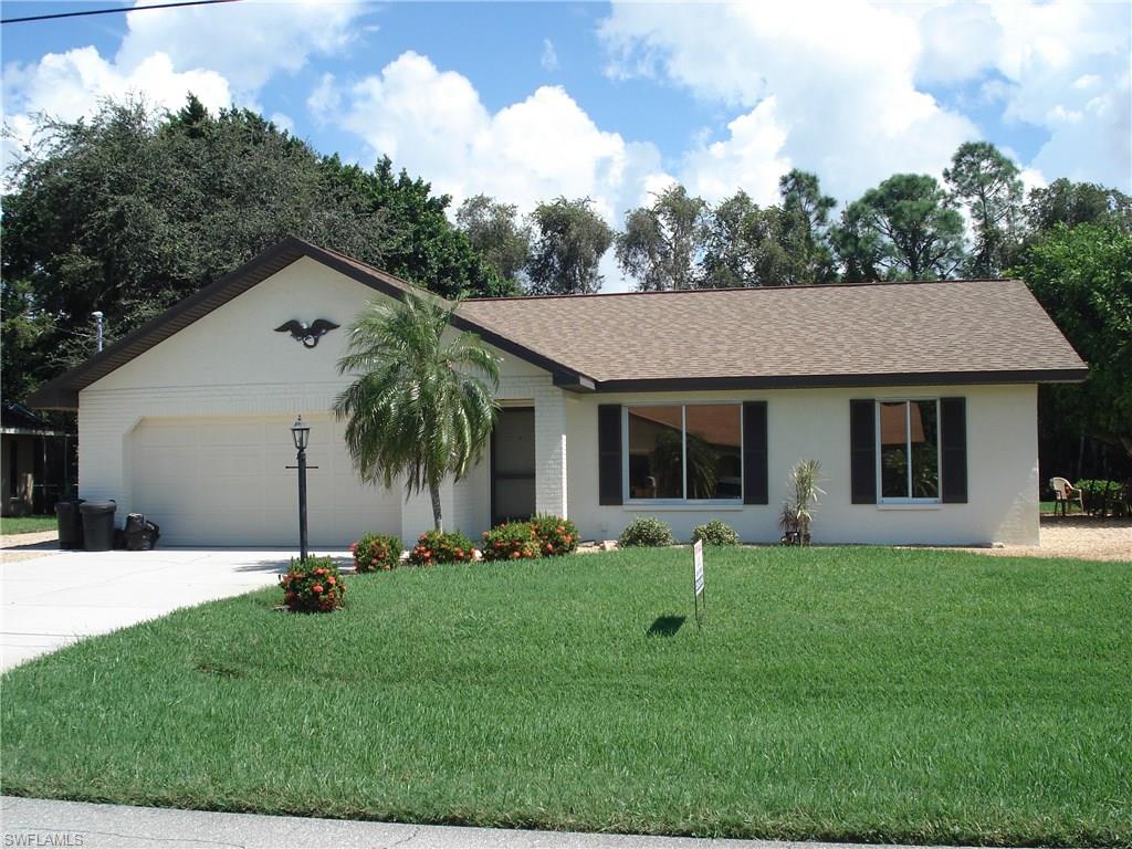 18057 Laurel Valley Road Fort Myers, FL 33967 - Photo 1 of 25 a front view of house with yard and green space