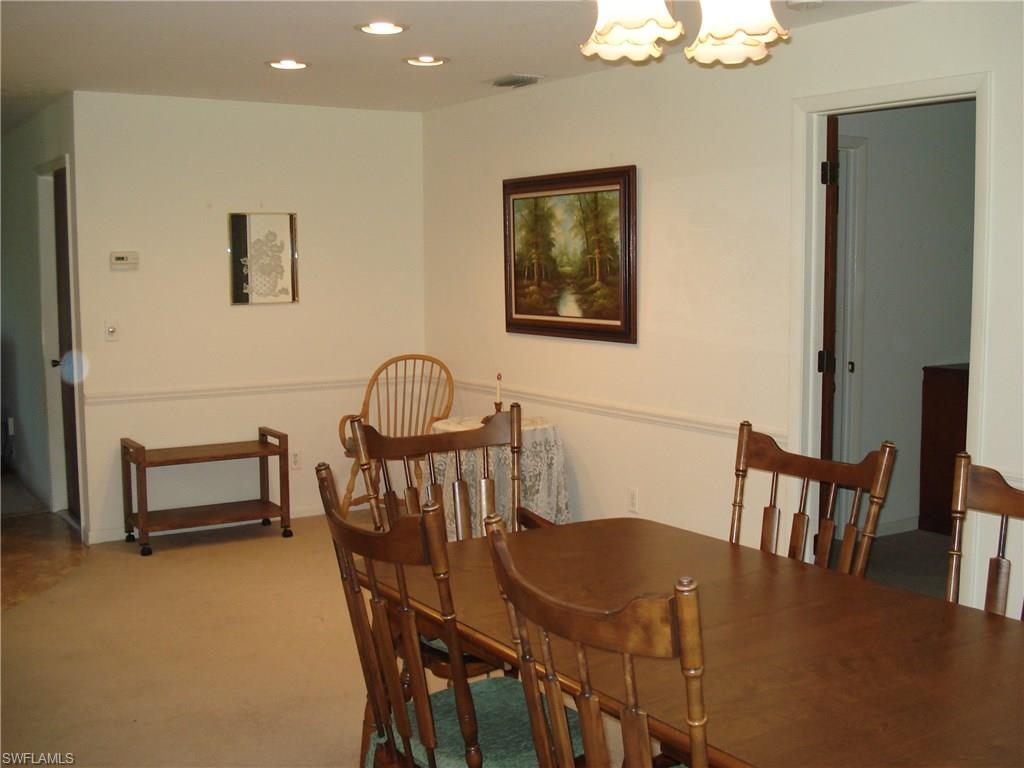 18057 Laurel Valley Road Fort Myers, FL 33967 - Photo 11 of 25 a view of a dining room with furniture and wooden floor