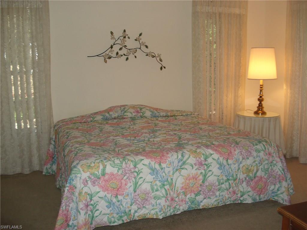 18057 Laurel Valley Road Fort Myers, FL 33967 - Photo 13 of 25 a bedroom with a bed