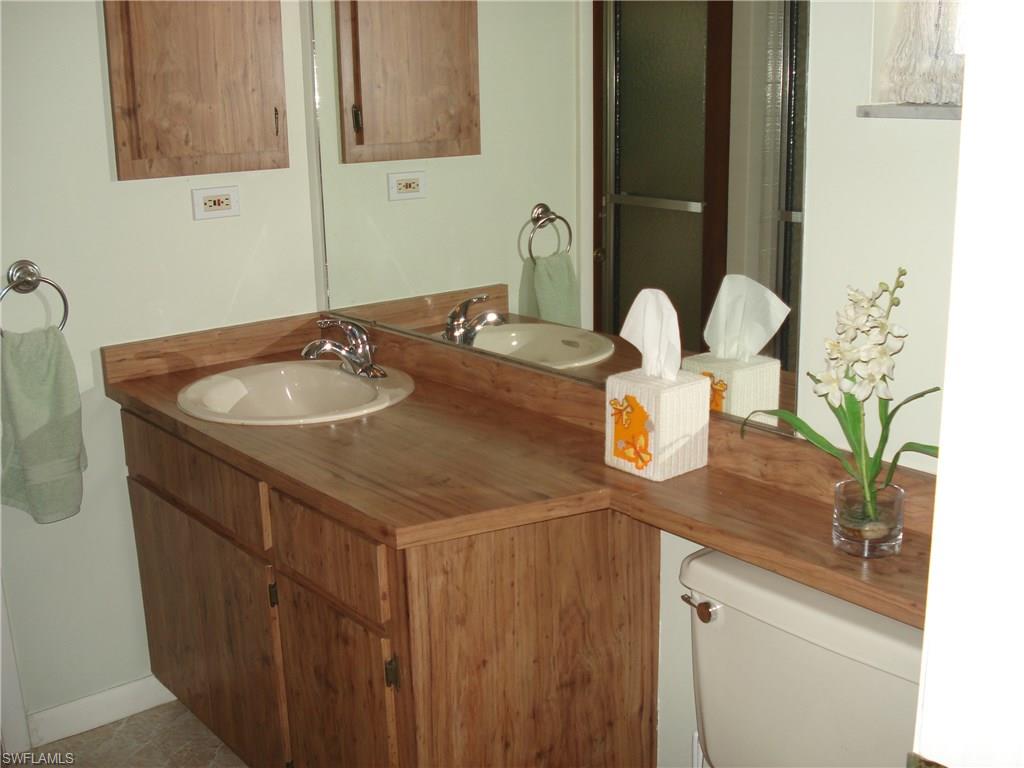 18057 Laurel Valley Road Fort Myers, FL 33967 - Photo 14 of 25 a bathroom with a sink and a mirror