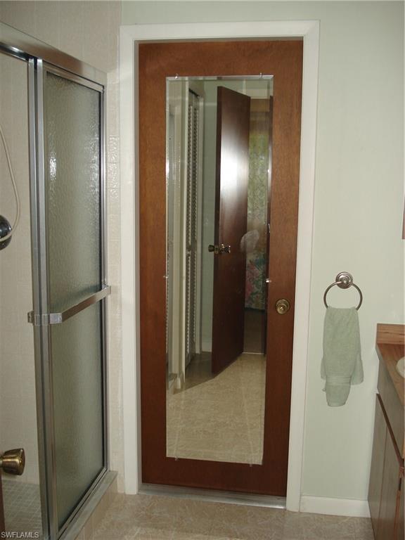 18057 Laurel Valley Road Fort Myers, FL 33967 - Photo 17 of 25 a bathroom with a glass shower door