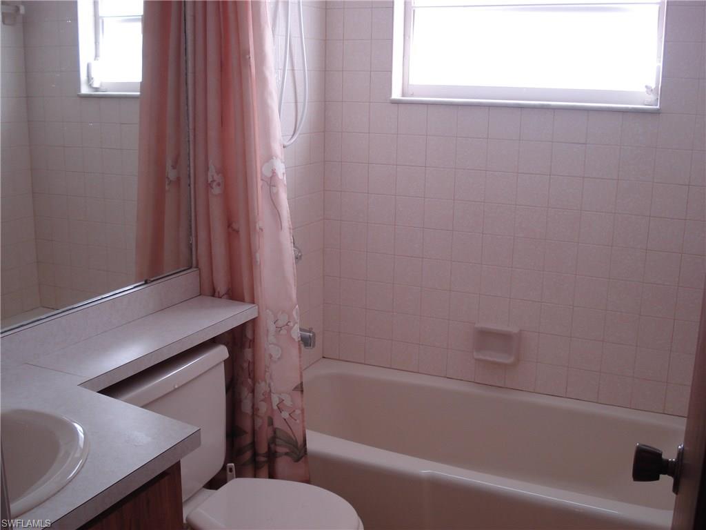 18057 Laurel Valley Road Fort Myers, FL 33967 - Photo 21 of 25 a bathroom with a toilet a sink and bathtub