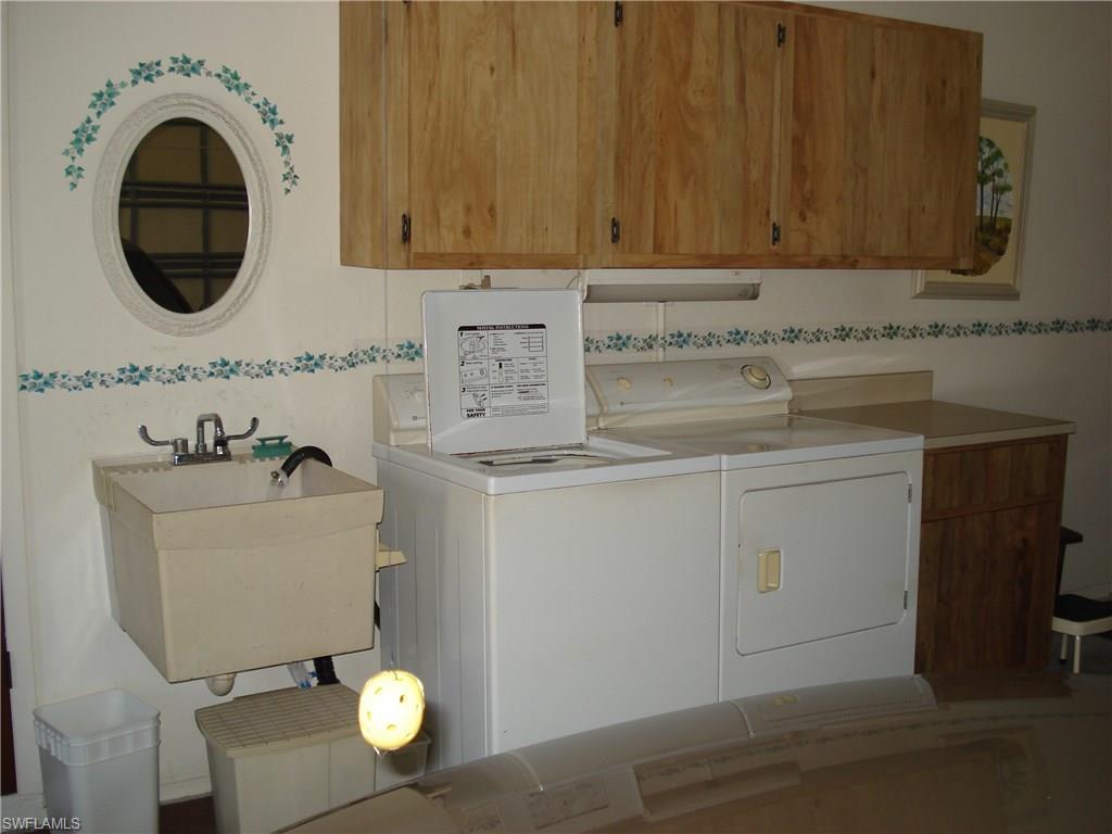 18057 Laurel Valley Road Fort Myers, FL 33967 - Photo 24 of 25 a bathroom with a sink and a mirror