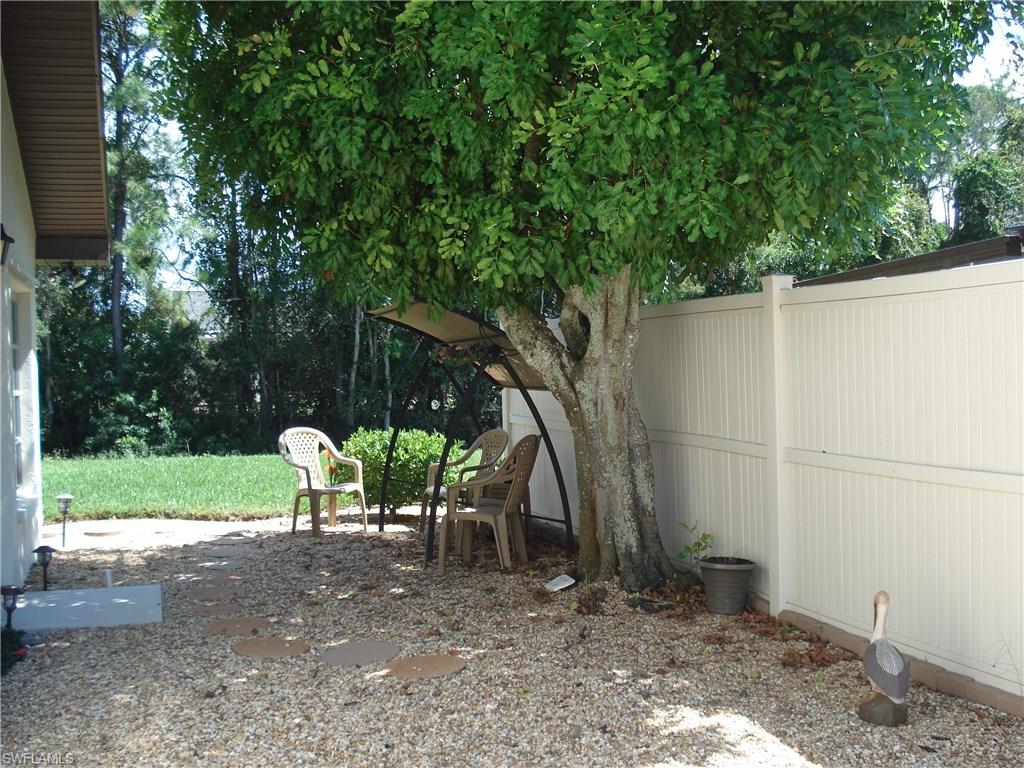 18057 Laurel Valley Road Fort Myers, FL 33967 - Photo 3 of 25 a view of a table and chair in the back yard