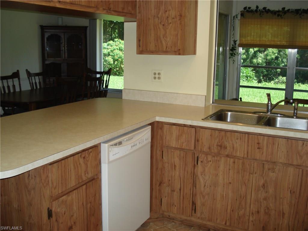 18057 Laurel Valley Road Fort Myers, FL 33967 - Photo 6 of 25 a kitchen with a sink and large window