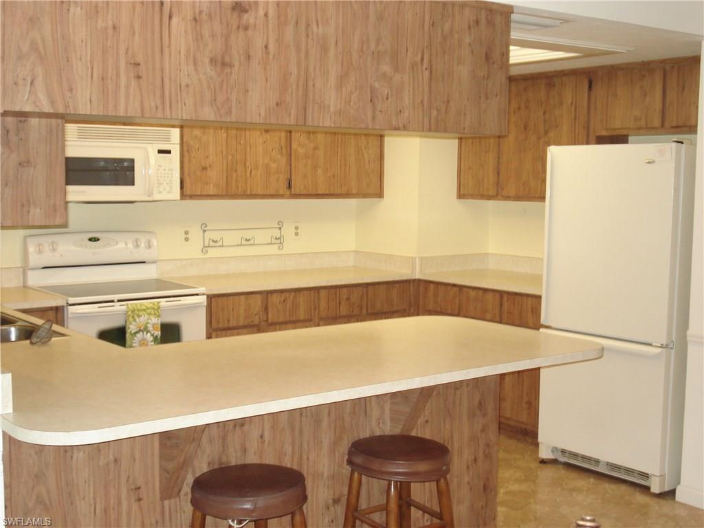 18057 Laurel Valley Road Fort Myers, FL 33967 - Photo 8 of 25 a bathroom with a sink and a refrigerator