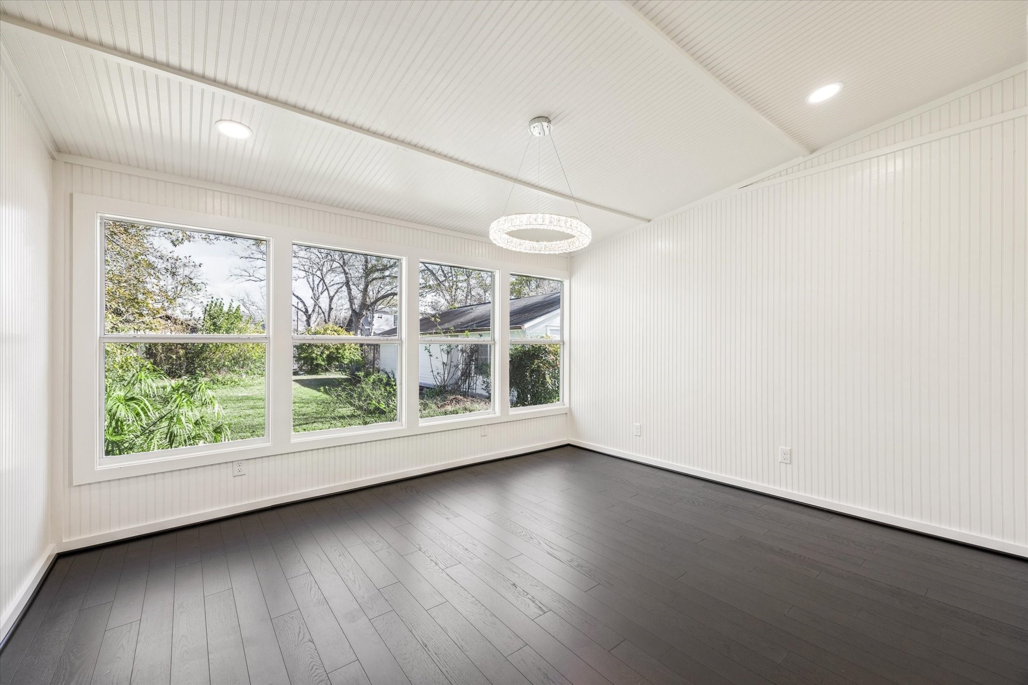 208 North Rusk Street Fayetteville, TX 78940 - Photo 8 of 17 an empty room with wooden floor and windows