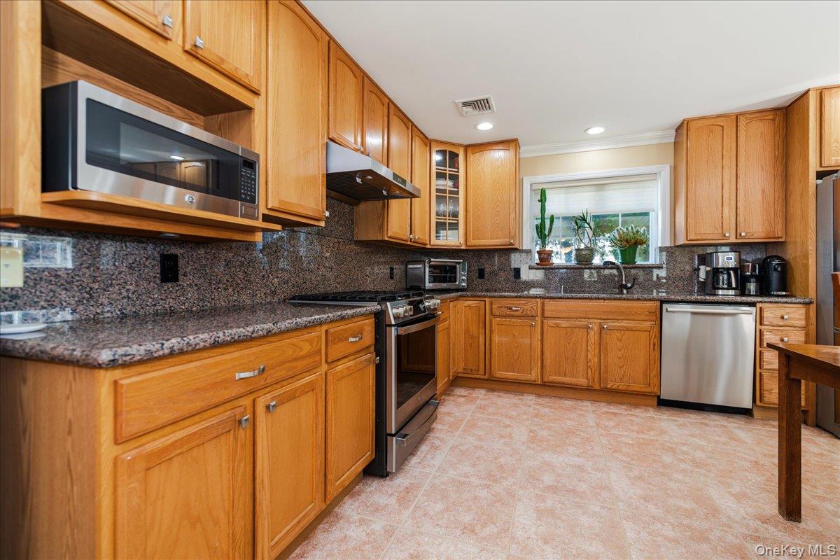 40 East Penn Street Long Beach, NY 11561 - Photo 15 of 41 a kitchen with a sink cabinets and stainless steel appliances