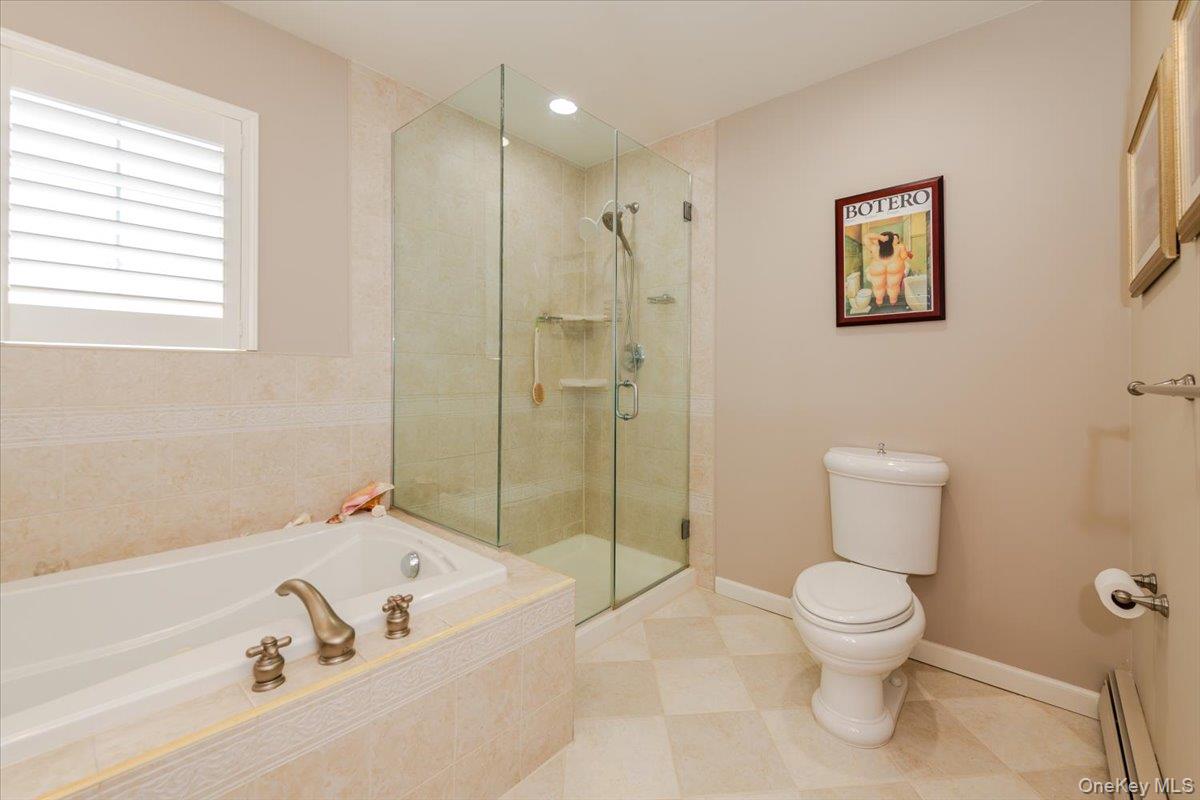 40 East Penn Street Long Beach, NY 11561 - Photo 21 of 41 a bathroom with a toilet and a shower