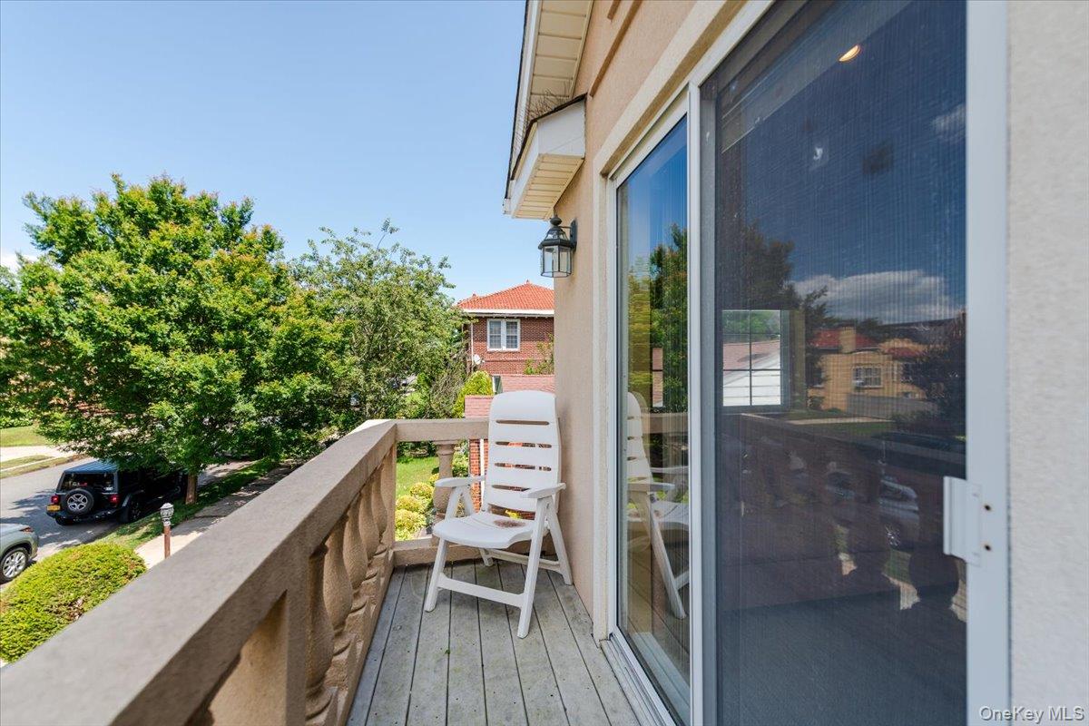 40 East Penn Street Long Beach, NY 11561 - Photo 28 of 41 a balcony with wooden floor and outdoor seating