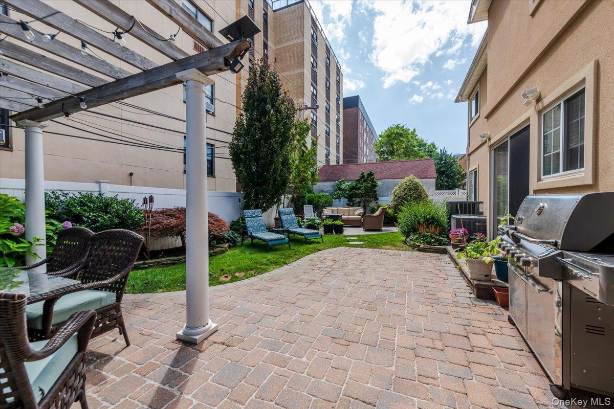 40 East Penn Street Long Beach, NY 11561 - Photo 31 of 41 a view of a patio with a table and chairs in a patio