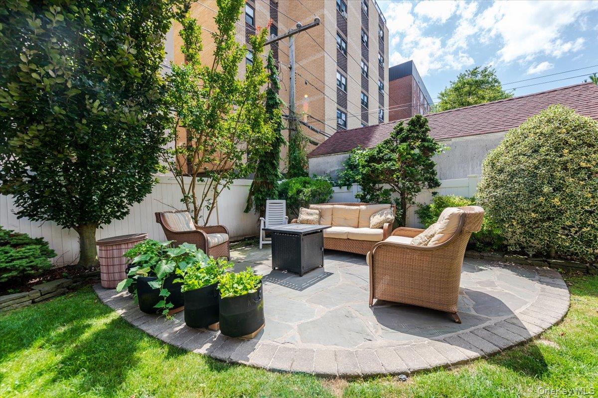 40 East Penn Street Long Beach, NY 11561 - Photo 32 of 41 a view of a patio with couches table and chairs and potted plants