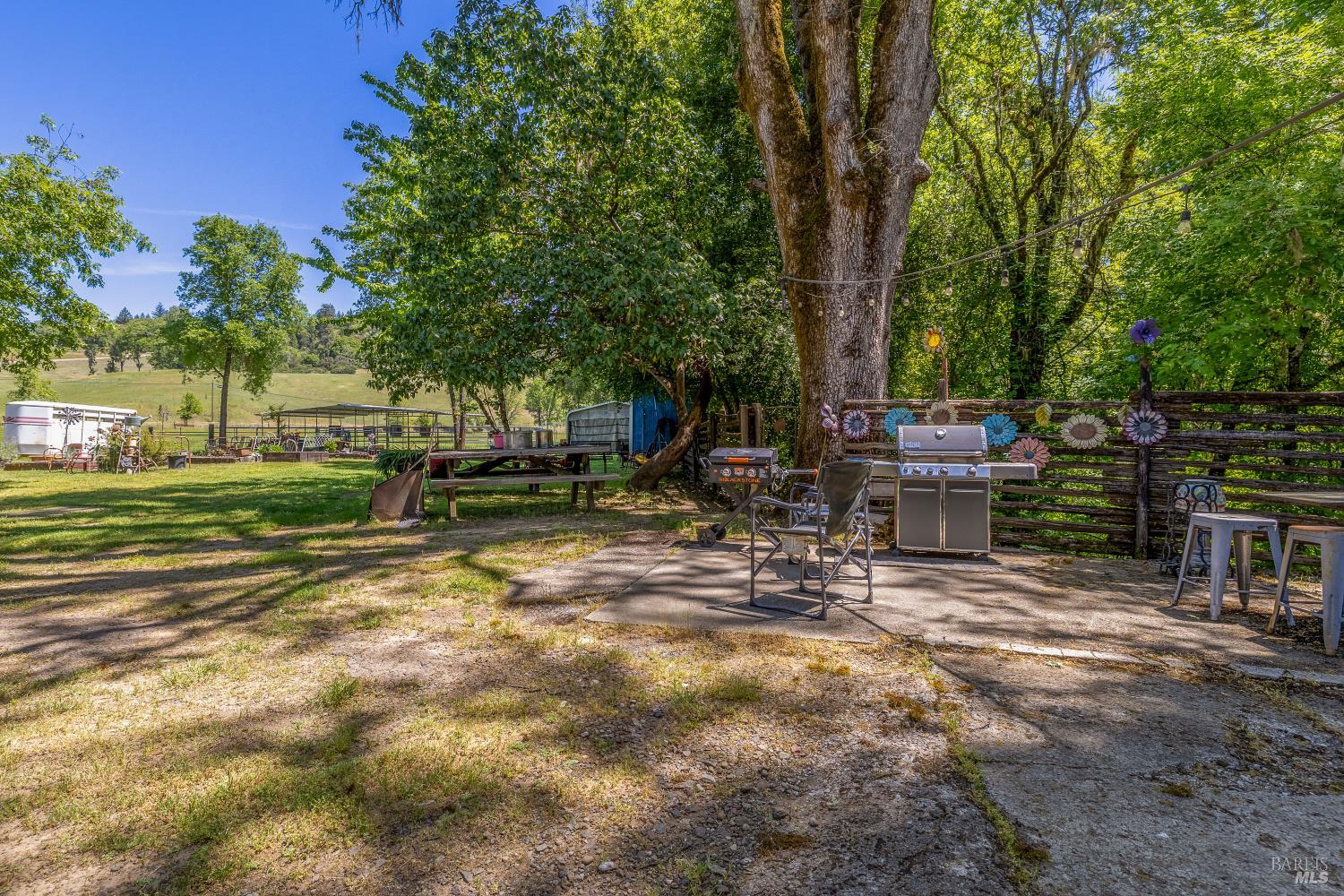 3901 Canyon Road Willits, CA 95490 - Photo 14 of 35 a view of backyard with a table and chairs and potted plants