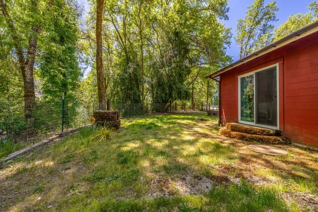 a backyard of a house with table and chairs