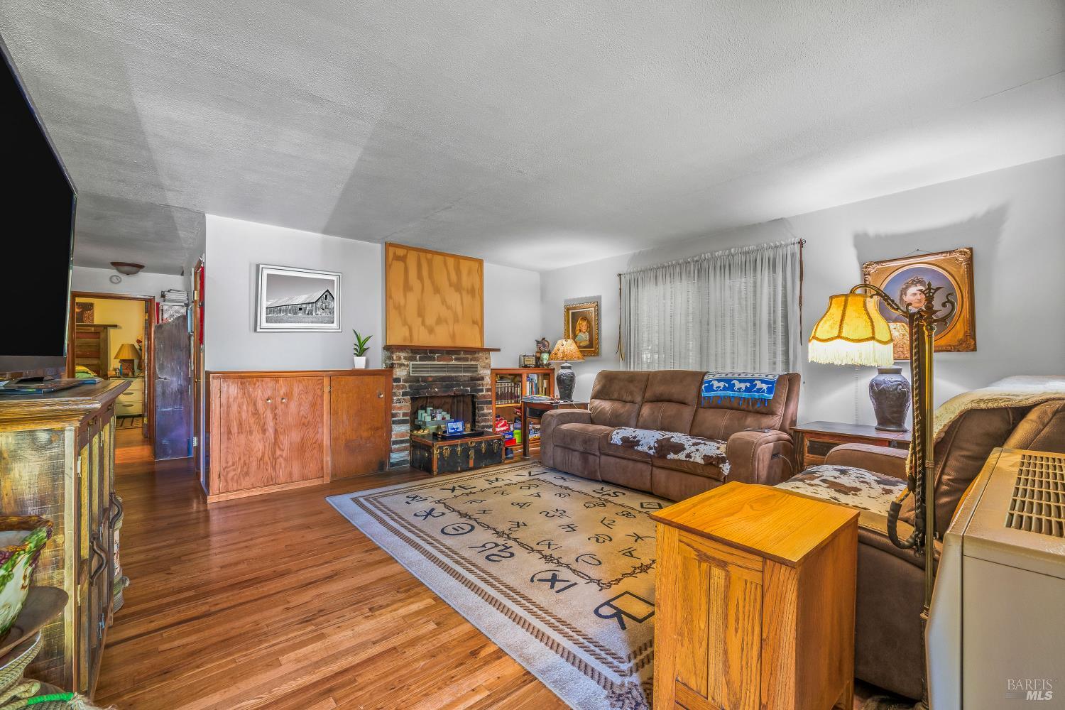 3901 Canyon Road Willits, CA 95490 - Photo 2 of 35 a living room with furniture and a flat screen tv