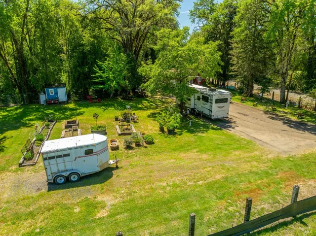 a backyard of a house with yard and outdoor seating