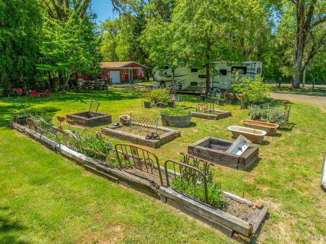 a view of a house with backyard and swimming pool