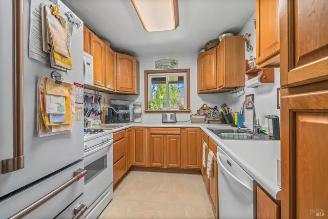 a kitchen with stainless steel appliances granite countertop lots of counter top space and windows