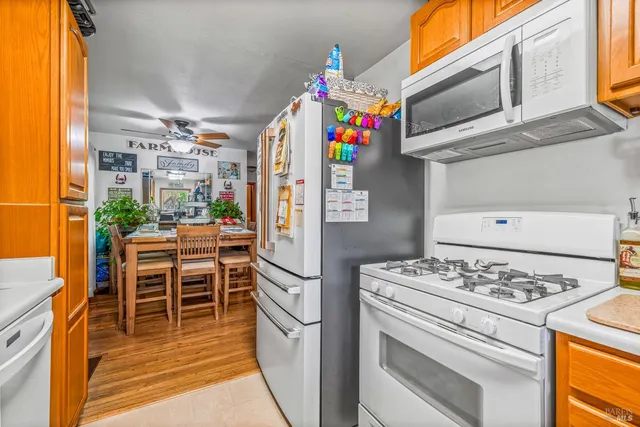 a kitchen with granite countertop a white stove and refrigerator