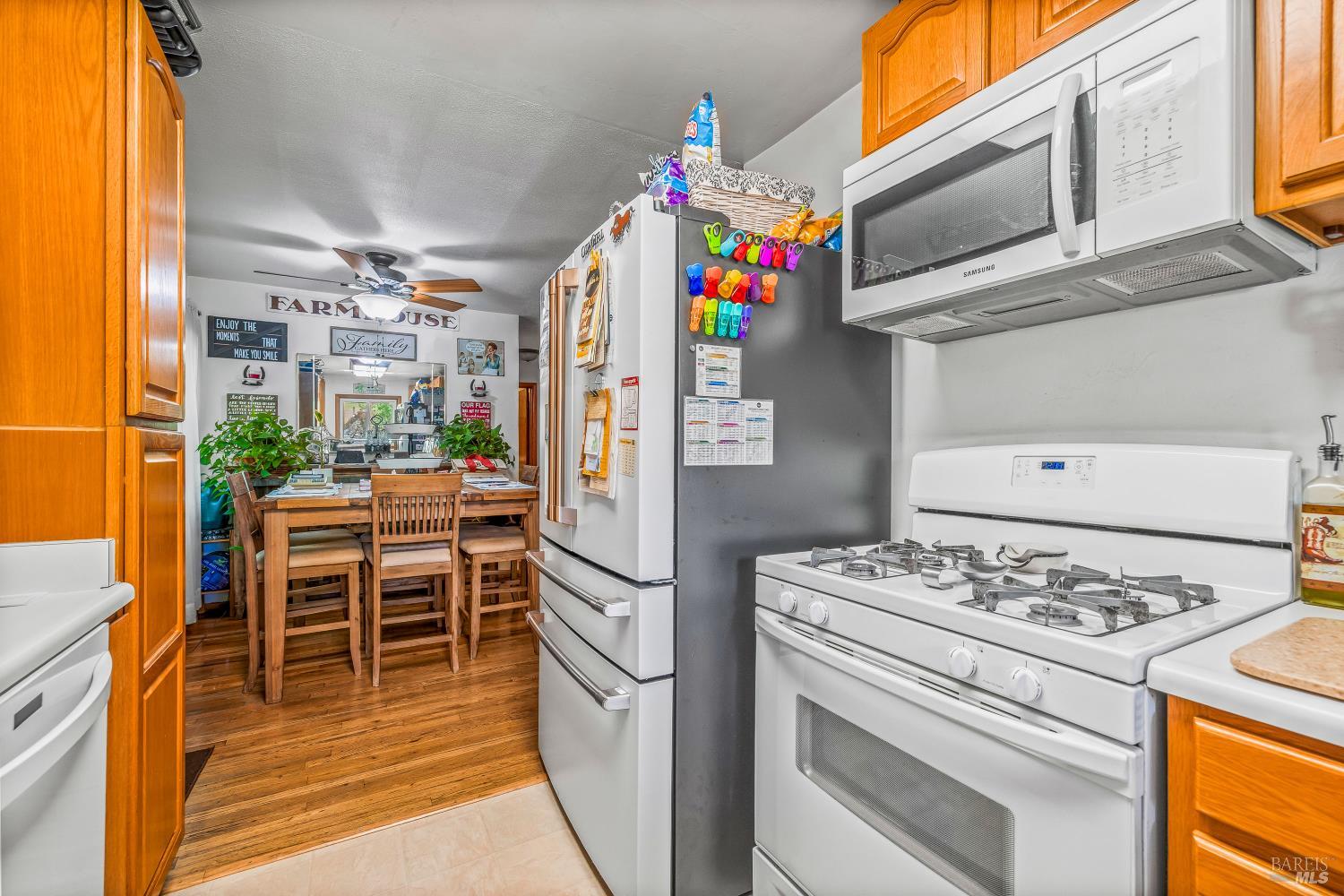 3901 Canyon Road Willits, CA 95490 - Photo 6 of 35 a kitchen with granite countertop a white stove and refrigerator