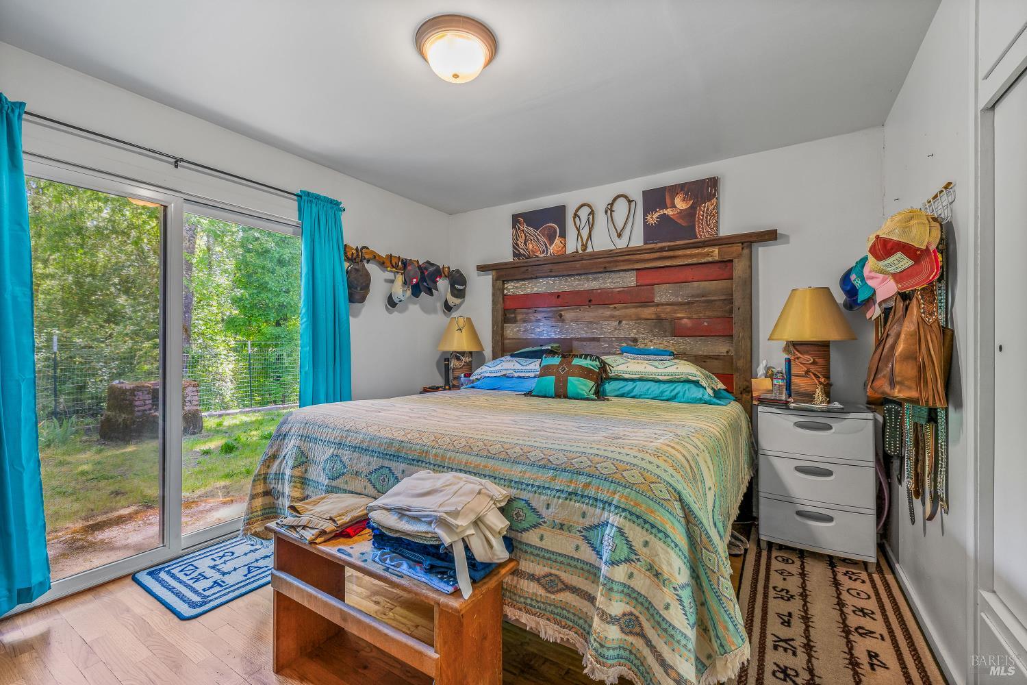 3901 Canyon Road Willits, CA 95490 - Photo 7 of 35 a bedroom with a bed and wooden floor