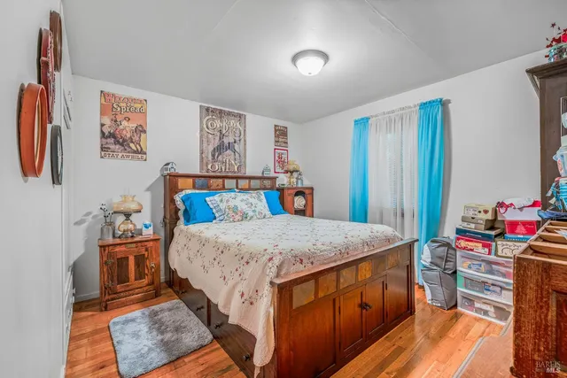 a bedroom with a bed and a dresser in it