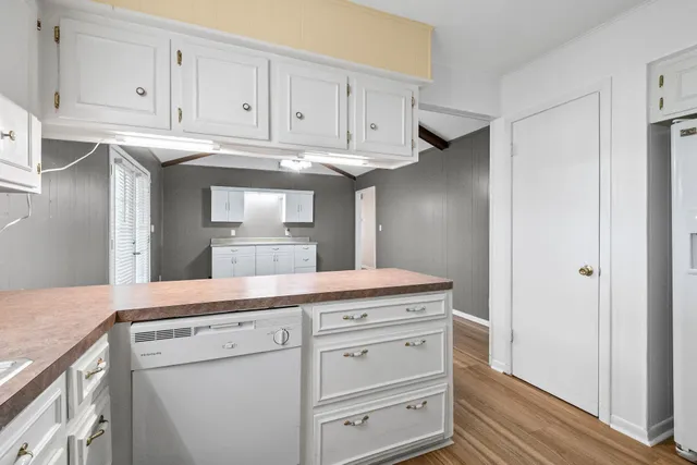 a kitchen with cabinets appliances and a counter top