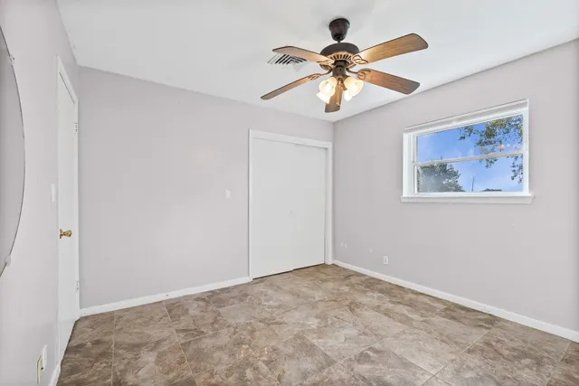 a view of an empty room with a fan