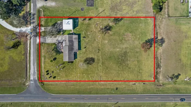 an aerial view of a residential houses with outdoor space