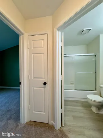 a bathroom with a shower and a toilet
