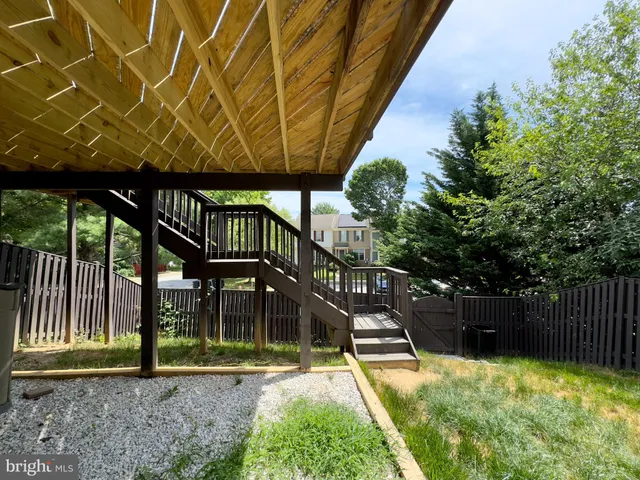 a view of a backyard with a small deck and a slide