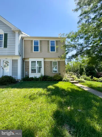 a front view of house with yard and trees