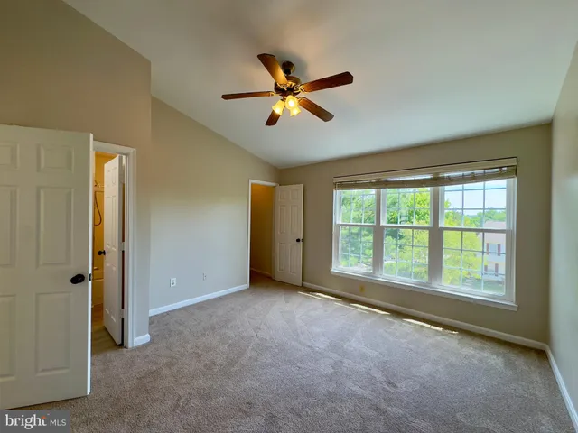 a view of a livingroom with a ceiling fan and window