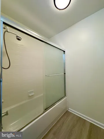 a bathroom with a glass shower door