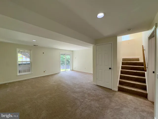 a view of an empty room with a fireplace