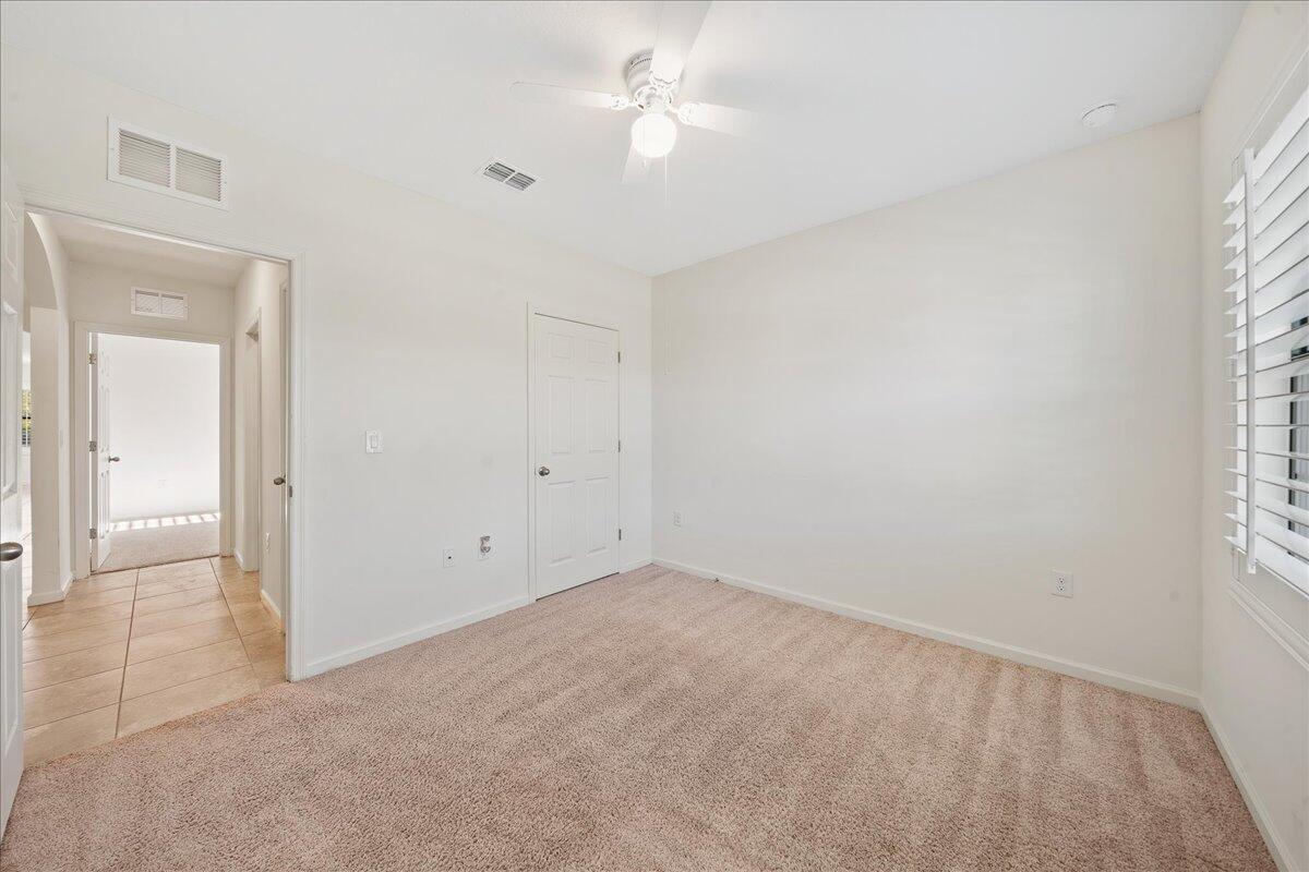 710 Old Country Rd S East Palm Bay, FL 32909 - Photo 17 of 27 an empty room with a ceiling fan and a window