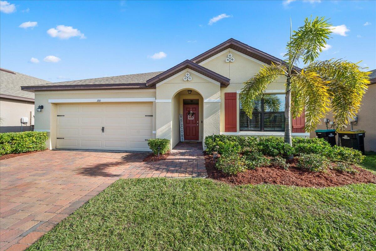 710 Old Country Rd S East Palm Bay, FL 32909 - Photo 22 of 27 a front view of a house with garden