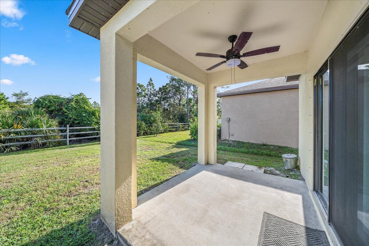 710 Old Country Rd S East Palm Bay, FL 32909 - Photo 25 of 27 a view of a porch with a floor to ceiling window and a yard