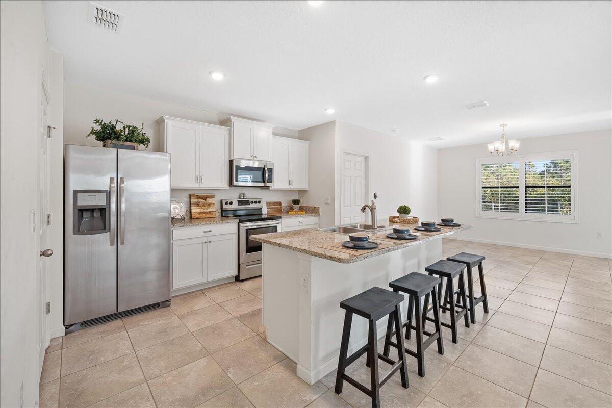 710 Old Country Rd S East Palm Bay, FL 32909 - Photo 3 of 27 a kitchen with appliances cabinets and a counter top space