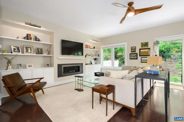 a living room with furniture fireplace and a flat screen tv
