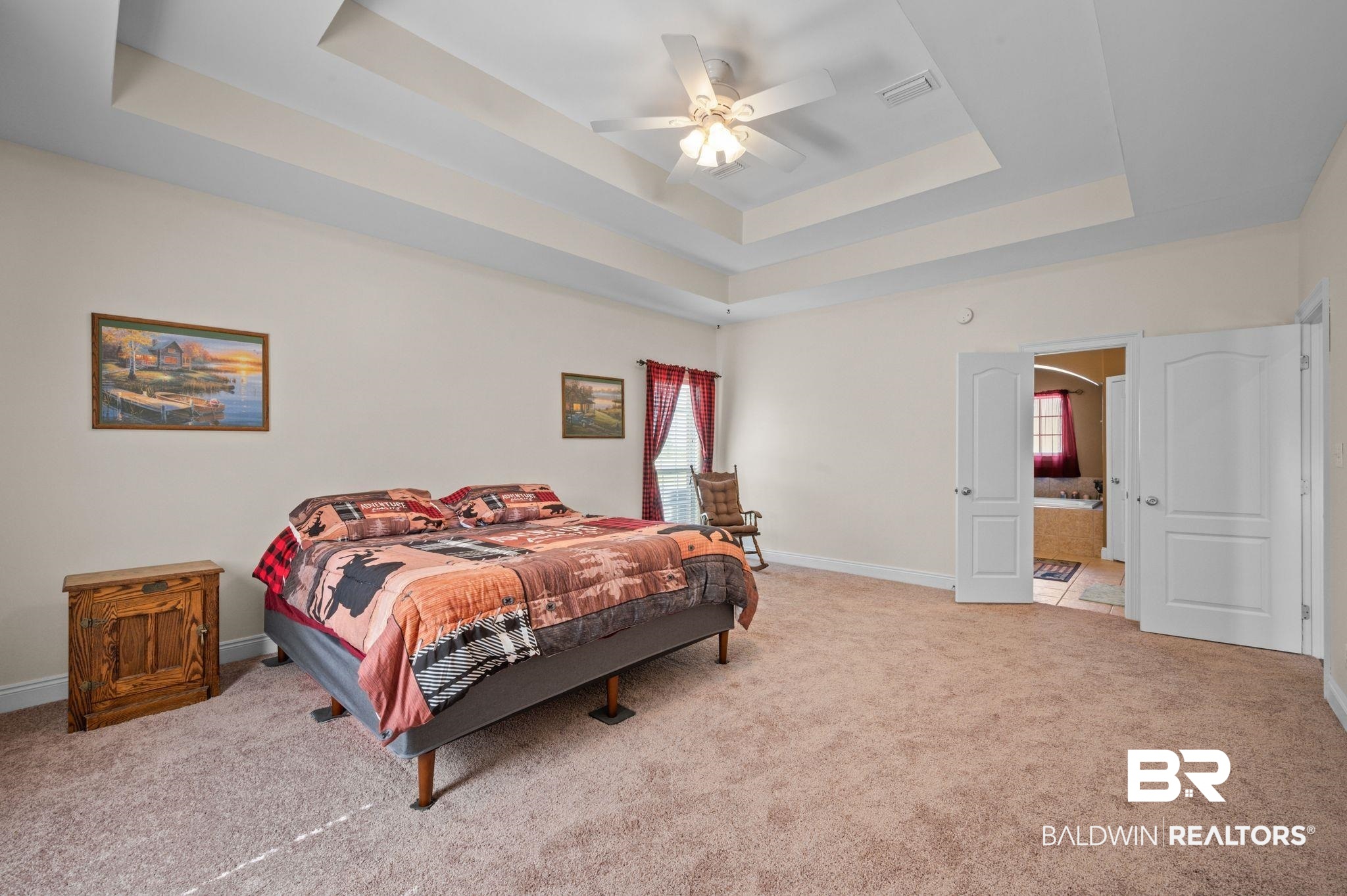 48513 Phillipsville Road Bay Minette, AL 36507 - Photo 21 of 50 Carpeted bedroom featuring a tray ceiling, a ceiling fan, ensuite bathroom, and arched walkways