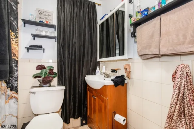 a bathroom with a toilet a sink and a mirror