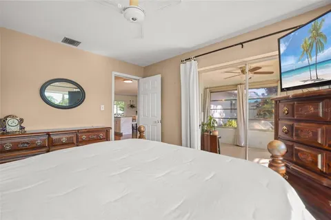 a bed room with a bed and a large window