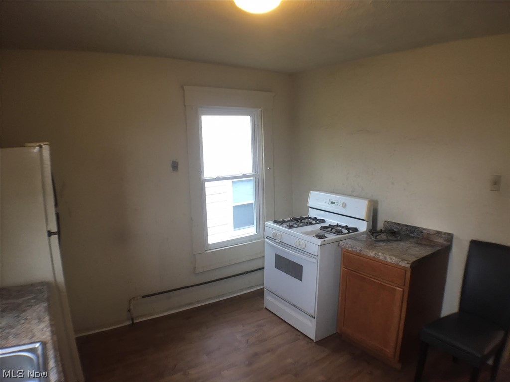 4016 Riverside Avenue Cleveland, OH 44109 - Photo 20 of 25 Kitchen with white appliances and dark hardwood / wood-style floors