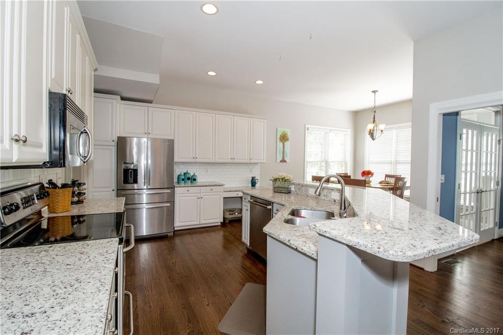 618 Lena Way Fort Mill, SC 29708 - Photo 10 of 24 a kitchen with a sink stainless steel appliances and white cabinets
